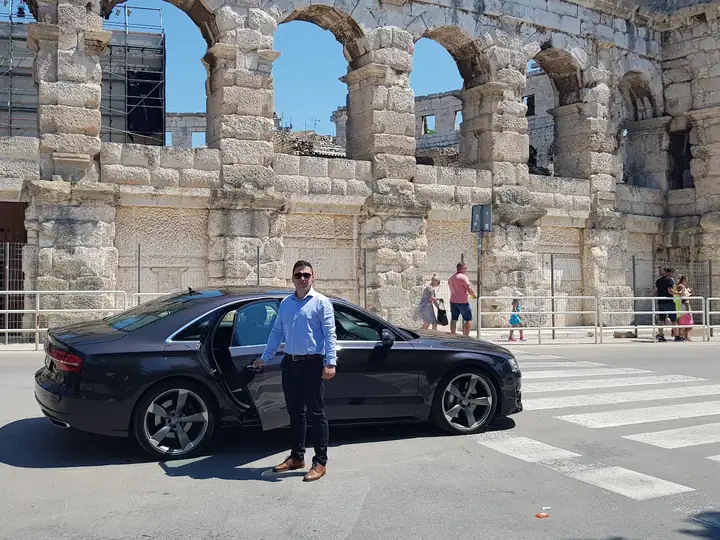 Car of Taxi Transfers Umag in front of the Roman amphitheatre in Pula