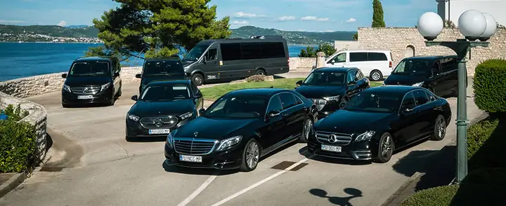 Cars and vans of Taxi Transfers Umag parked by the sea in Umag