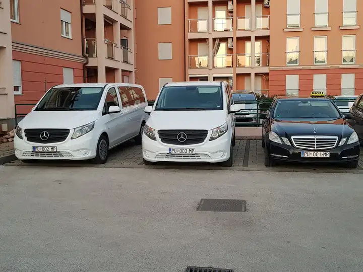 White Mercedes Vito vans and an E-Class taxi